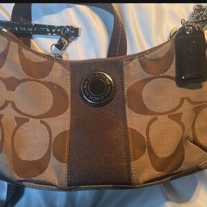 Coach Brown Shoulder Bag with Interlocking C Pattern and Curved Shape
